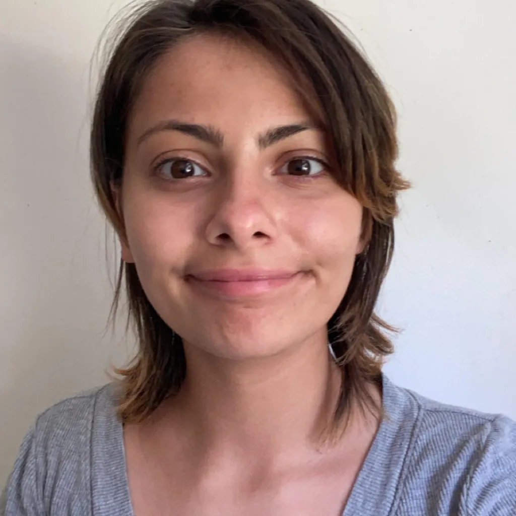 person with short hair and grey shirt