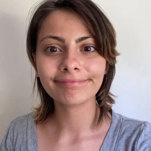 person with short hair and grey shirt