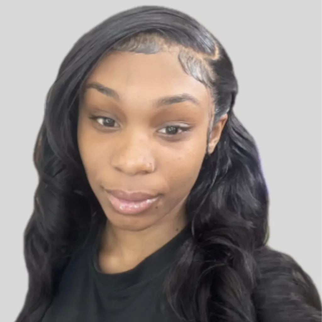 Headshot of Lived Experience (LEx) Leader Knowledge Grant, wearing a black top, with long wavy black hair and a nose ring, against a grey background.